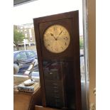 An art deco grandfather clock with pendulum weights and key