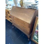 An oak bureau with three drawers