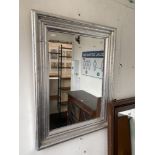 A silver framed bevelled mirror