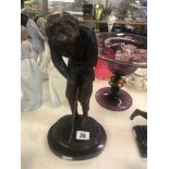 A bronze figure of a golfer