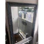 A silver framed mirror