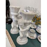 A pair of marble cherub candlesticks