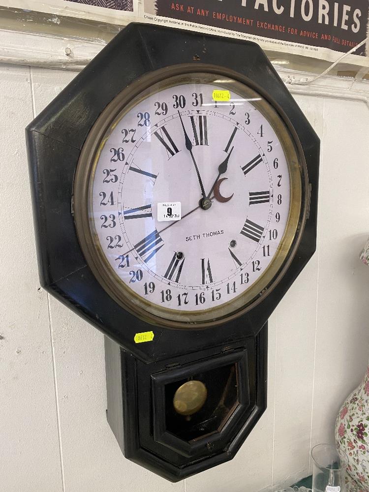 A Victorian wall clock with pendulum and key,