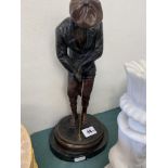 A bronze figure of a golfer