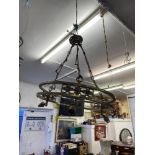 A circular brass hanging light fitting