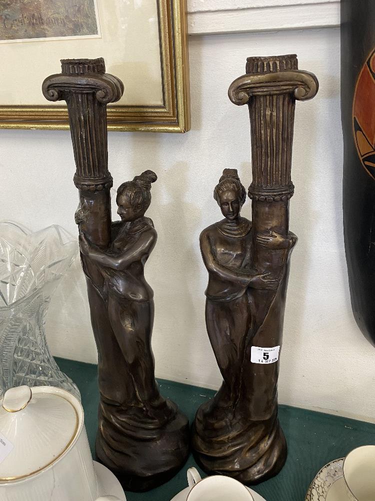 A pair of art deco style figural candle sticks