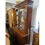 A Victorian walnut bookcase on cupboard base