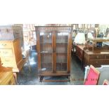 An Ercol oak display cabinet