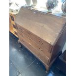 An oak bureau with three drawers