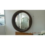 A circular wicker framed mirror