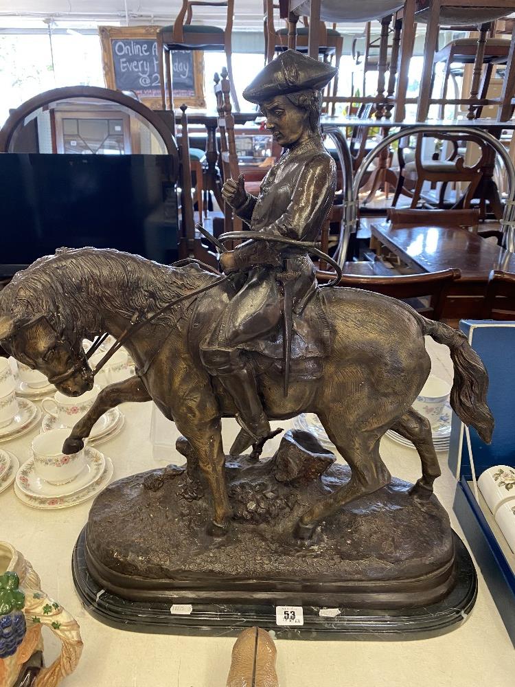 A bronze huntsman on a horse