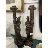 A pair of art deco style figural candle sticks