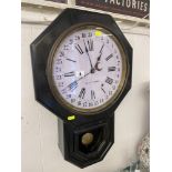 A Victorian wall clock with pendulum and key,