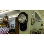 A Victorian wall clock with pendulum and key,