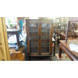 An Ercol oak display cabinet