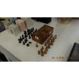 A boxed set of chess pieces, some pieces a.