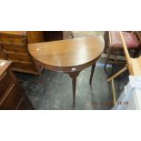 Two demi lune tables