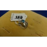 A platinum diamond and blue topaz ring, size O,