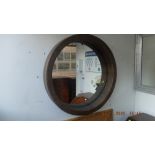 A circular wicker framed mirror