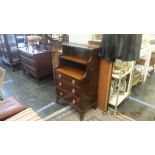 A mahogany side cabinet with gallery