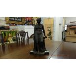 A metal figure of a lady with spear