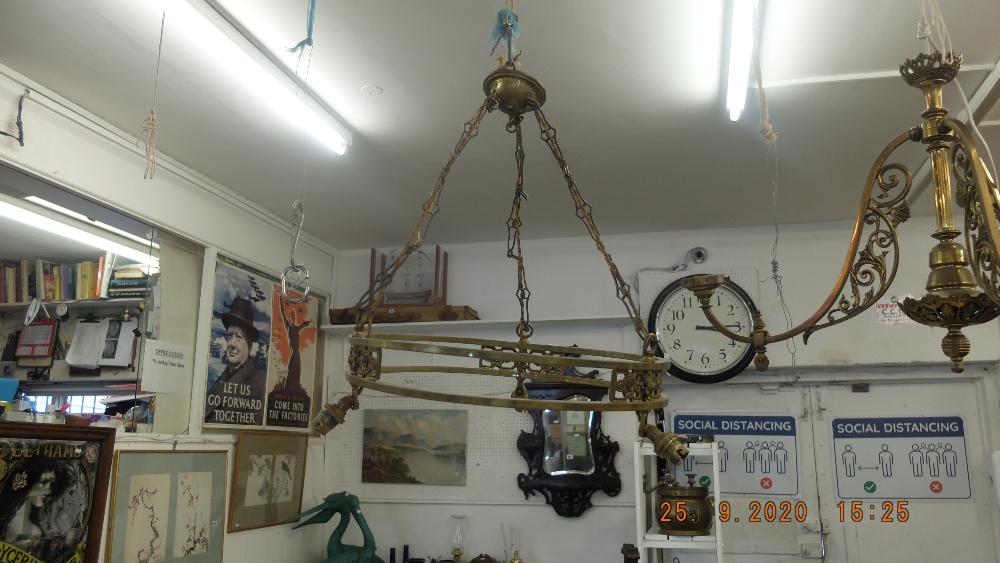 A circular brass hanging light fitting