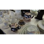 Three piece tea set with teapot stand