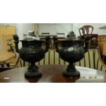 A pair of pewter urns on stand