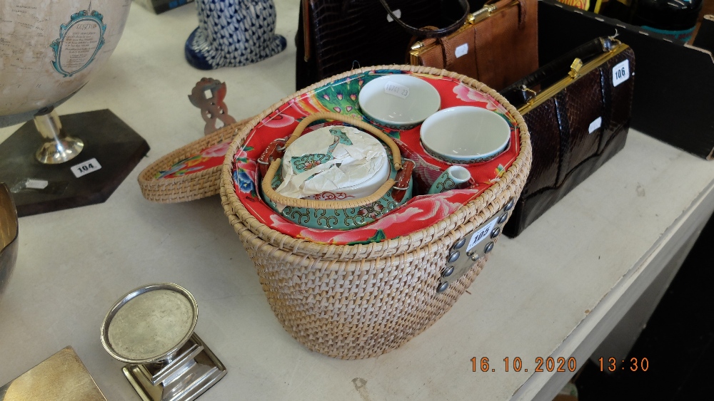 An oriental tea set in basket