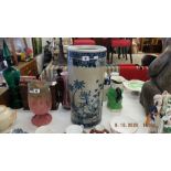 A blue and white oriental umbrella stand