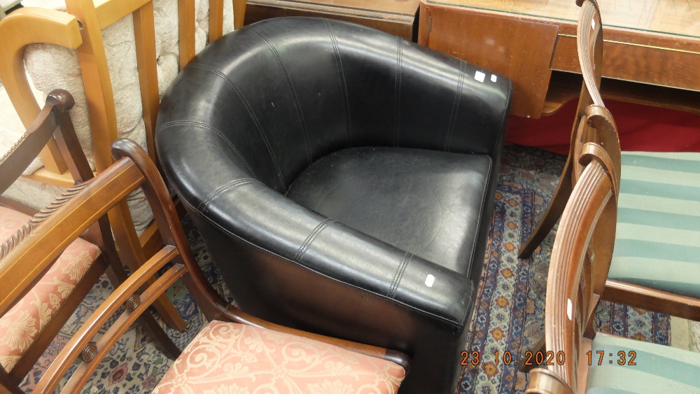 A black leather tub chair