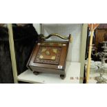 An antique mahogany and brass coal perdonium