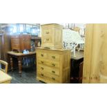 An oak chest of drawers and a bedside cabinet