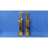 A pair of art deco style figural candle sticks