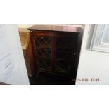 Glass fronted bookcase, with key a.