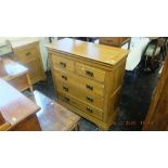 An oak chest of drawers and a bedside cabinet