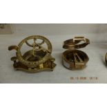 Two brass compasses one with a sundial