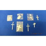 Seven hallmarked silver crosses and a dog tag