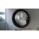 A circular wicker framed mirror