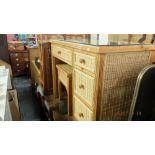 A rattan suite; desk, armchair,