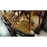 A mahogany extending dining table with extra leaf