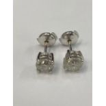 An 18ct white gold hallmarked pair of natural diamond earrings, 2.