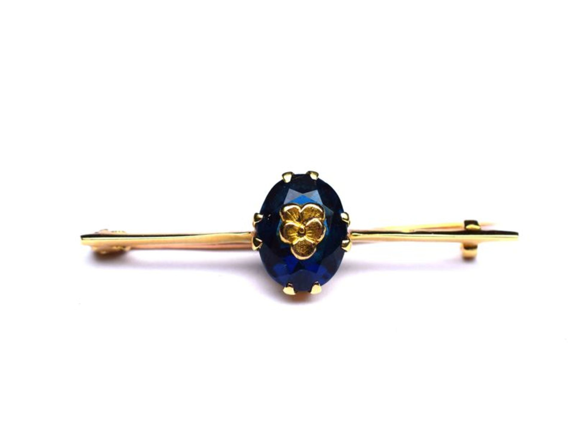 Broche or jaune centrée d'une pierre bleue incrustée d'un motif or -or 2,6 g. -