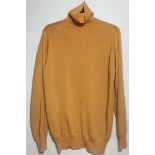 PAUL WELLER OWNED JUMPER. An orange roll neck woolen jumper (M) owned and worn by Paul Weller.