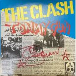 JOE STRUMMER SIGNED CLASH SLEEVE. A copy of The Clash - Tommy Gun signed in red ink by Joe Strummer.