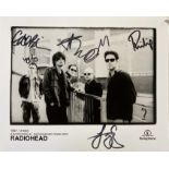 RADIOHEAD SIGNED PHOTO. A promotional 8 x 10" photograph signed by all five members of Radiohead.