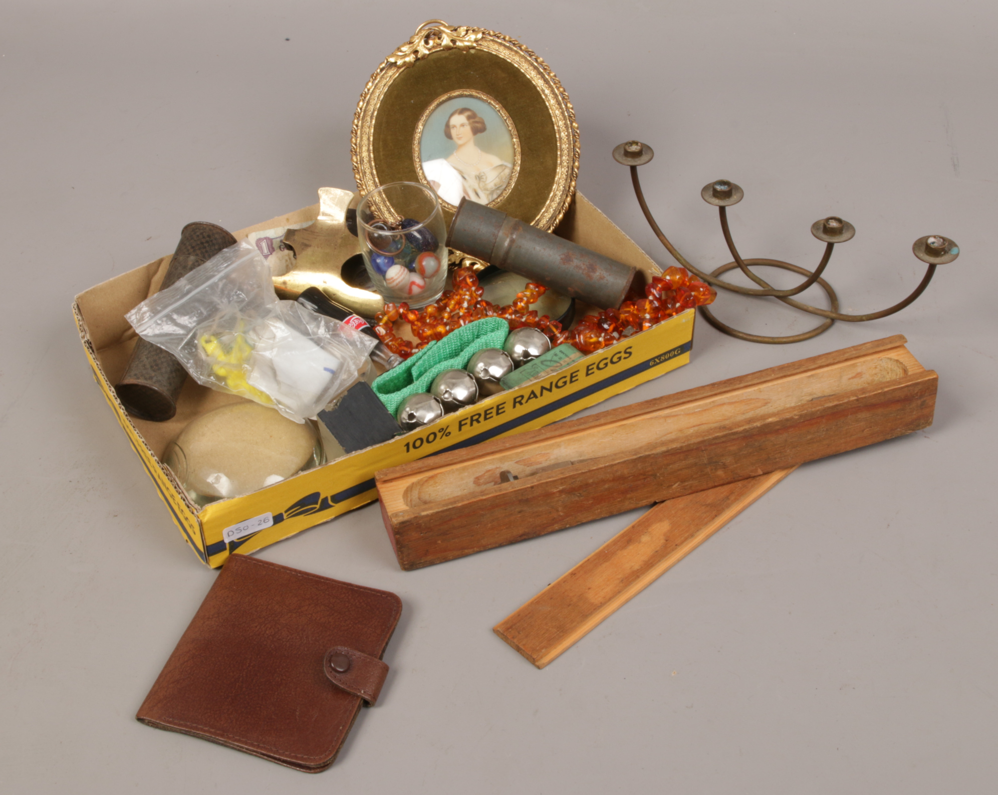 A box of collectables to include amber necklace, magnifying glass, brass bulldog clip etc.