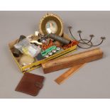A box of collectables to include amber necklace, magnifying glass, brass bulldog clip etc.
