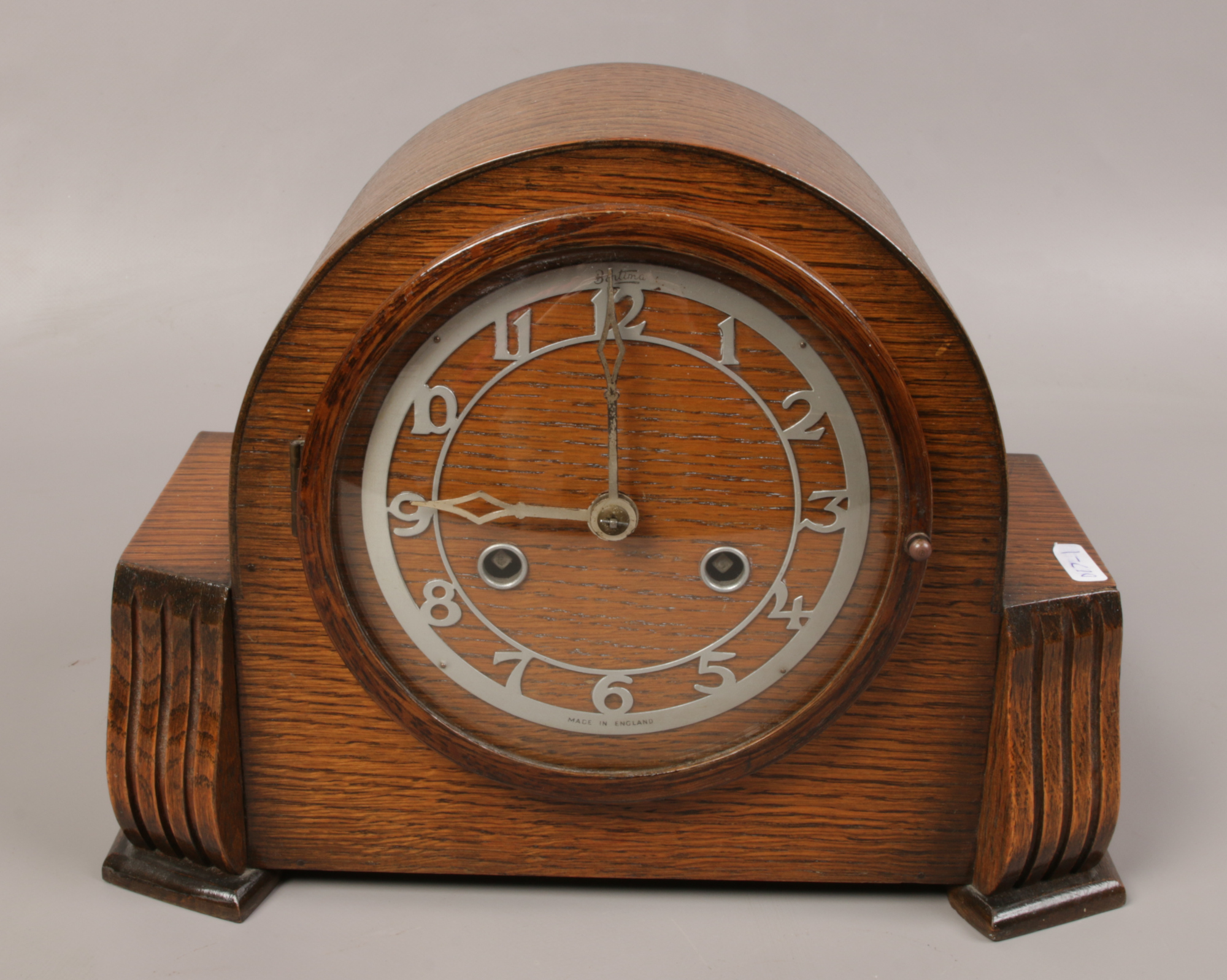 An oak Bentima mantle clock, chiming on a coiled gong. No key.