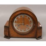 An oak Bentima mantle clock, chiming on a coiled gong. No key.